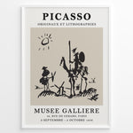 Load image into Gallery viewer, Framed Picasso Don Quixote art poster with minimalist black sketch of riders and windmills on a beige background.

