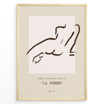 Load image into Gallery viewer, Framed “La Femme No.07” poster with minimalist brown line art of a reclining female silhouette on a beige and blush background.
