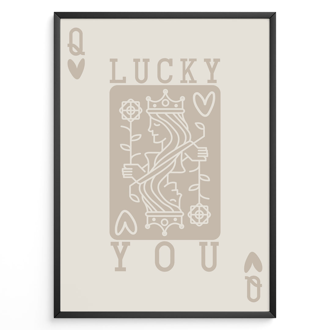 Framed minimalist “Lucky You” poster featuring Queen of Hearts playing card design in beige tones on a neutral background.