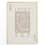 Load image into Gallery viewer, Framed minimalist “Lucky You” poster featuring Queen of Hearts playing card design in beige tones on a neutral background.
