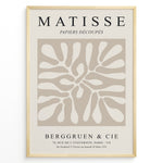 Load image into Gallery viewer, Framed Matisse Papiers Découpés poster with abstract beige cut-out shapes and black typography on a neutral background.
