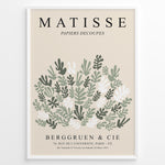 Load image into Gallery viewer, Framed Matisse-style botanical poster with abstract green and white leaf cutout shapes and beige background, titled “Papiers Découpés.”
