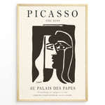Load image into Gallery viewer, Framed Picasso “The Kiss” poster with two abstract faces in black on a beige background.

