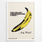 Load image into Gallery viewer, Framed Andy Warhol Banana art poster featuring The Velvet Underground &amp; Nico text on a beige background.
