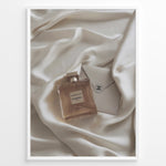 Load image into Gallery viewer, Fashion Plakat | Gabrielle Chanel Perfume on Silk with Envelope – Luxury Flat Lay Print Plakaty.dk | Gabrielle Chanel Essence perfume bottle and Chanel envelope placed on soft ivory silk fabric in a luxury flat lay composition.

