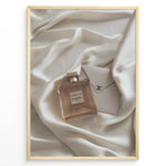 Load image into Gallery viewer, Fashion Plakat | Gabrielle Chanel Perfume on Silk with Envelope – Luxury Flat Lay Print Plakaty.dk | Gabrielle Chanel Essence perfume bottle and Chanel envelope placed on soft ivory silk fabric in a luxury flat lay composition.
