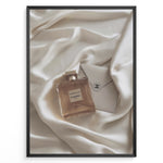 Load image into Gallery viewer, Fashion Plakat | Gabrielle Chanel Perfume on Silk with Envelope – Luxury Flat Lay Print Plakaty.dk | Gabrielle Chanel Essence perfume bottle and Chanel envelope placed on soft ivory silk fabric in a luxury flat lay composition.
