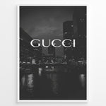 Load image into Gallery viewer, Fashion Plakat | Gucci Cityscape Black &amp; White Fashion Poster Plakaty.dk | Black and white poster with the Gucci logo over a night cityscape featuring tall buildings and water reflections.
