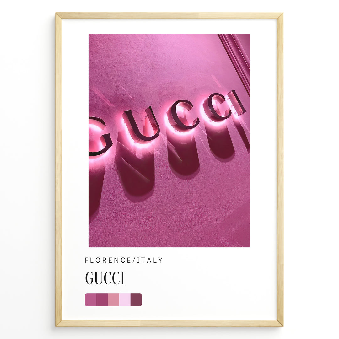 Fashion Plakat | Gucci Storefront Wall Art – Florence Italy Plakaty.dk | Gucci logo in glowing pink neon lights on a textured wall in Florence, Italy, with a modern color palette and shadows creating a bold visual effect.