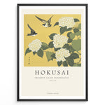 Load image into Gallery viewer, Japanske plakater | Japanese woodblock print of white trumpet lilies with green leaves and two sparrows flying against a yellow background, based on Hokusai’s  floral artwork.
