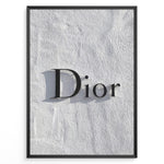 Load image into Gallery viewer, Fashion Plakat | Minimalist Dior Wall Sign – Timeless Fashion Statement Plakaty.dk | Minimalist black Dior logo mounted on a textured white wall, casting a soft shadow and evoking luxury and elegance.

