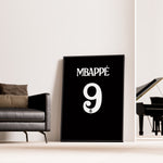 Load image into Gallery viewer, Kylian Mbappé Fodbold Plakat | Til Real Madrid Fans | Denne plakat viser Kylian Mbappé i en ikonisk Real Madrid trøje, klar til at score mål. Perfekt til fodboldfans og specielt Real Madrid entusiaster.
