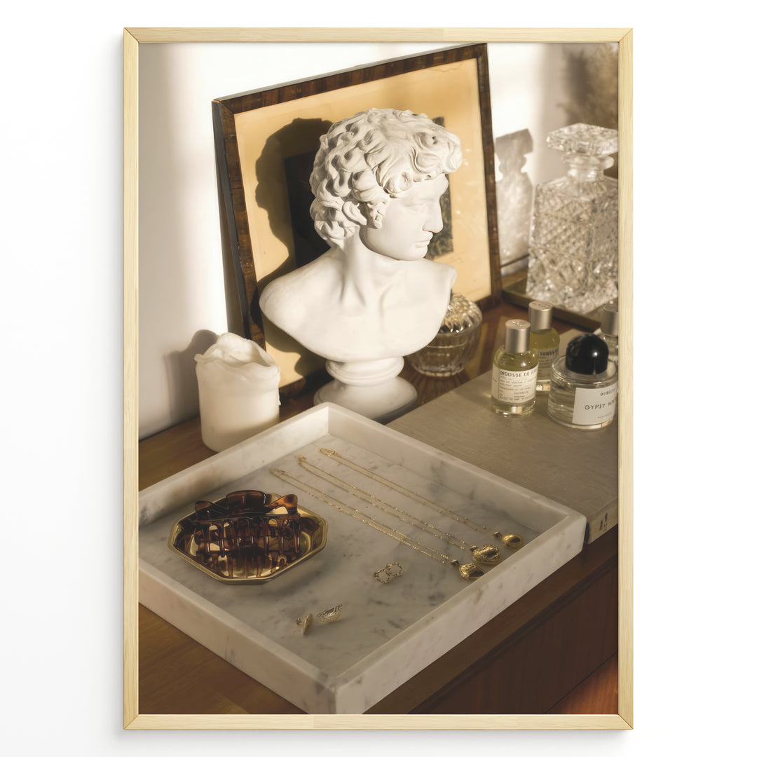 Fashion Plakat | Modern Vanity Scene with Sculptural Bust, Jewelry, and Perfume – Aesthetic Interior Print Plakaty.dk | Stylish vanity setup with a white classical bust, gold jewelry on a marble tray, designer perfumes, and crystal glassware in warm lighting.