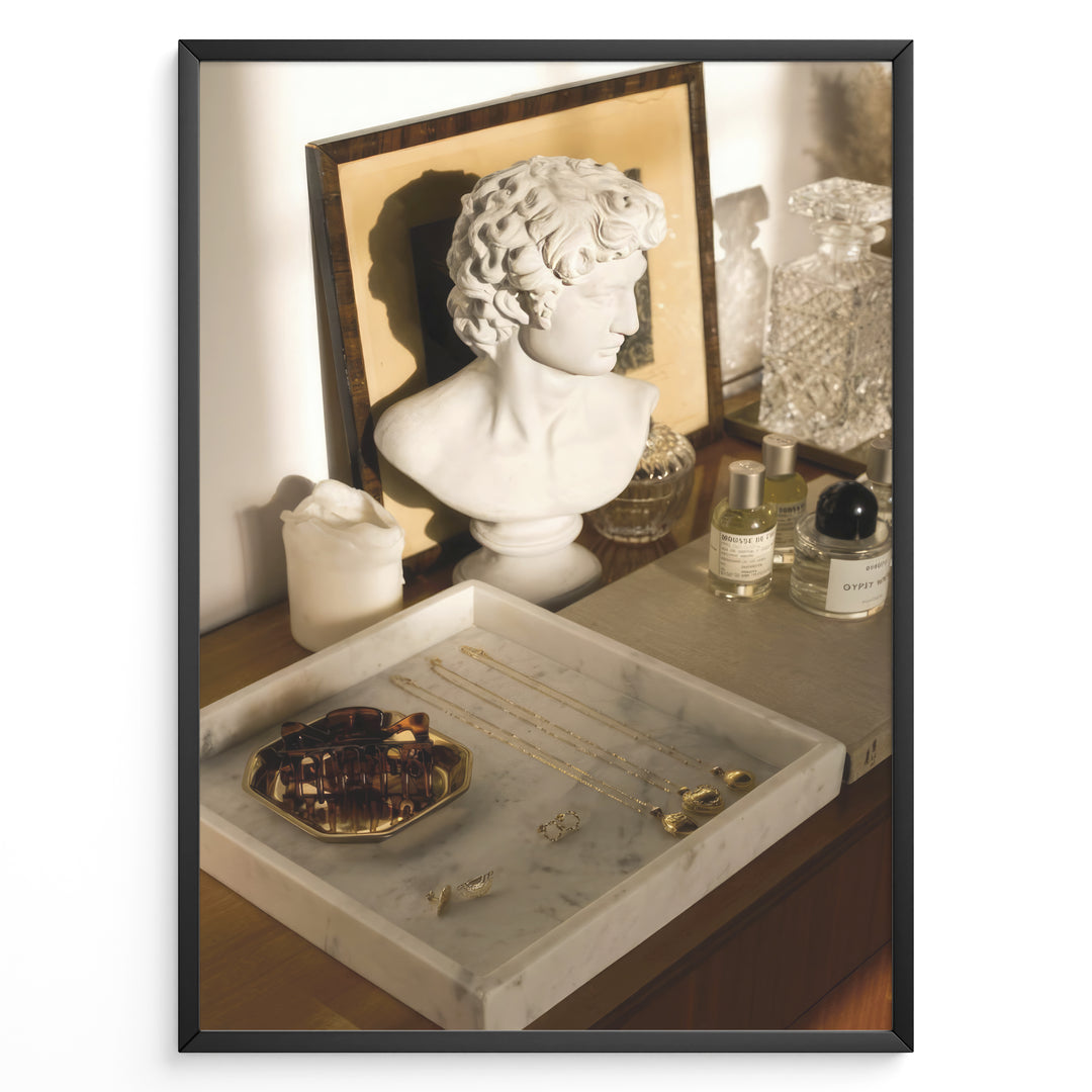 Fashion Plakat | Modern Vanity Scene with Sculptural Bust, Jewelry, and Perfume – Aesthetic Interior Print Plakaty.dk | Stylish vanity setup with a white classical bust, gold jewelry on a marble tray, designer perfumes, and crystal glassware in warm lighting.
