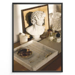 Load image into Gallery viewer, Fashion Plakat | Modern Vanity Scene with Sculptural Bust, Jewelry, and Perfume – Aesthetic Interior Print Plakaty.dk | Stylish vanity setup with a white classical bust, gold jewelry on a marble tray, designer perfumes, and crystal glassware in warm lighting.

