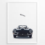 Load image into Gallery viewer, Framed minimalist poster of a black Jaguar E-Type classic sports car front view with the Jaguar leaping logo above on a white background.
