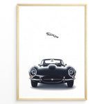 Load image into Gallery viewer, Framed minimalist poster of a black Jaguar E-Type classic sports car front view with the Jaguar leaping logo above on a white background.
