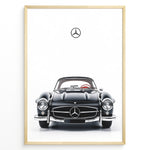 Load image into Gallery viewer, Framed minimalist poster of a black Mercedes-Benz 300SL classic convertible car front view with Mercedes logo above on a white background.
