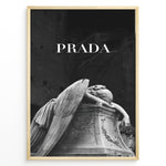 Load image into Gallery viewer, Fashion Plakat | Prada-Inspired Angel Statue – Fashion and Art Black and White Poster Plakaty.dk | Black and white artwork of a mourning angel statue with the word &quot;PRADA&quot; above, blending classical art and modern fashion
