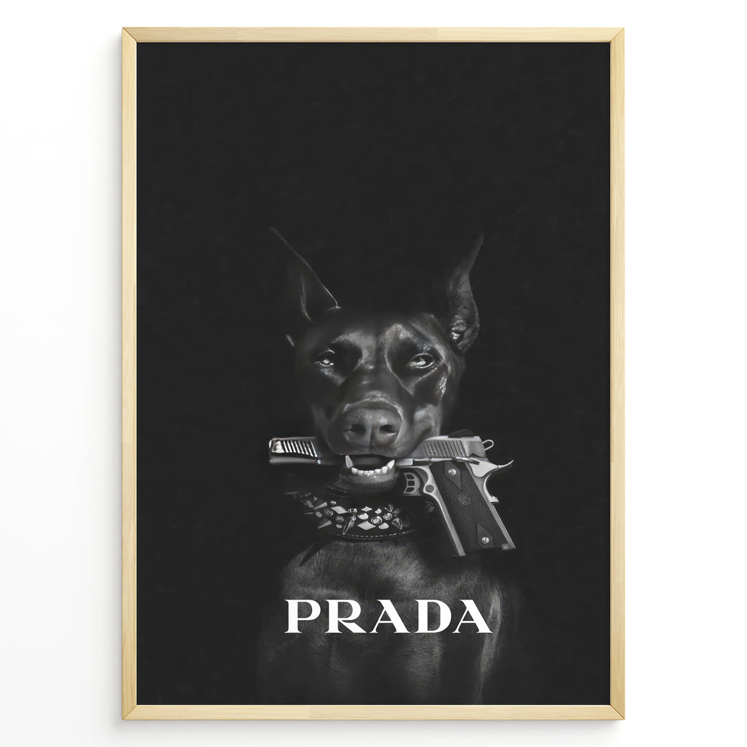 Fashion Plakat | Prada-Inspired Art Featuring Fierce Dog with Gun Plakaty.dk | Black Doberman with a studded collar holding a handgun in its mouth, set against a dark background with the word "PRADA" in bold white text.