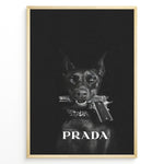 Load image into Gallery viewer, Fashion Plakat | Prada-Inspired Art Featuring Fierce Dog with Gun Plakaty.dk | Black Doberman with a studded collar holding a handgun in its mouth, set against a dark background with the word &quot;PRADA&quot; in bold white text.
