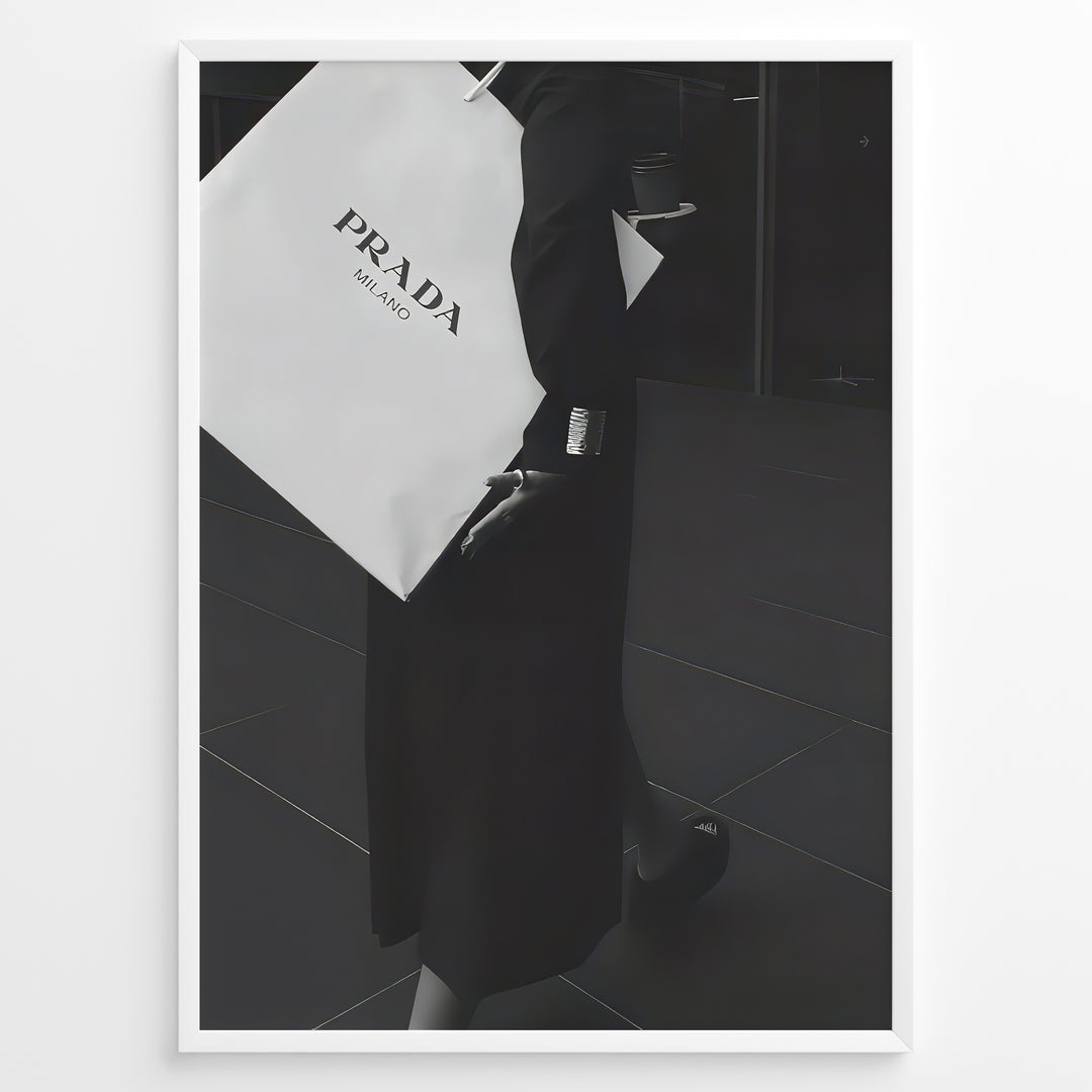 Fashion Plakat | Prada Shopping Bag Fashion Photography Wall Art Plakaty.dk | Black and white photo of a person holding a large Prada Milano shopping bag, dressed in elegant dark clothing.