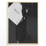 Load image into Gallery viewer, Fashion Plakat | Prada Shopping Bag Fashion Photography Wall Art Plakaty.dk | Black and white photo of a person holding a large Prada Milano shopping bag, dressed in elegant dark clothing.
