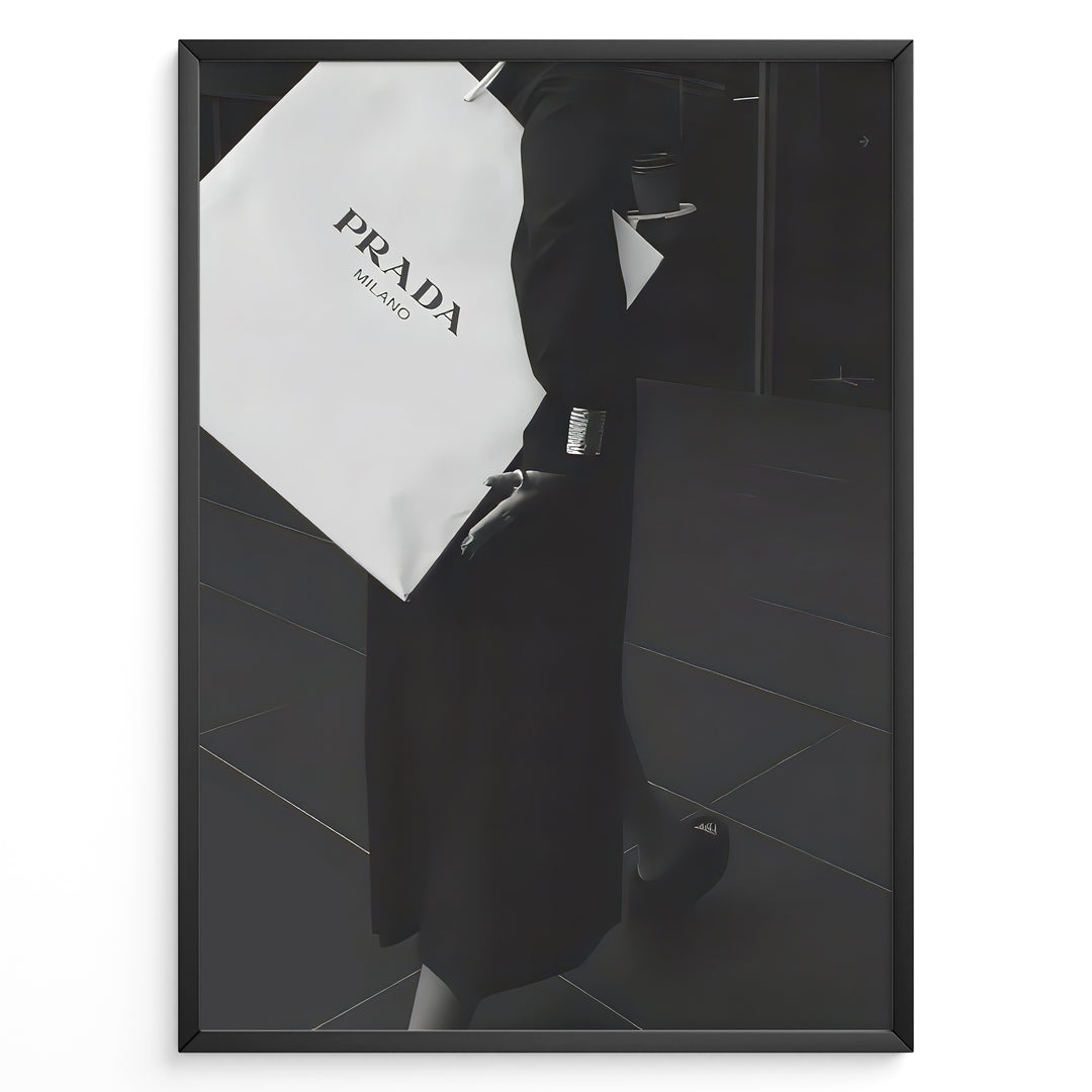 Fashion Plakat | Prada Shopping Bag Fashion Photography Wall Art Plakaty.dk | Black and white photo of a person holding a large Prada Milano shopping bag, dressed in elegant dark clothing.