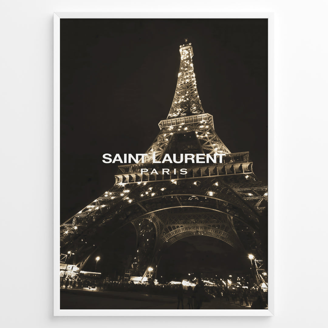 Fashion Plakat | Saint Laurent Eiffel Tower Night View – Paris Fashion Wall Art Plakaty.dk | Illuminated Eiffel Tower at night with "Saint Laurent Paris" logo centered in white text.
