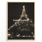 Load image into Gallery viewer, Fashion Plakat | Saint Laurent Eiffel Tower Night View – Paris Fashion Wall Art Plakaty.dk | Illuminated Eiffel Tower at night with &quot;Saint Laurent Paris&quot; logo centered in white text.
