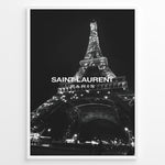 Load image into Gallery viewer, Fashion Plakat | Saint Laurent Eiffel Tower Poster – Black &amp; White Paris Fashion Print Plakaty.dk | Black and white photo of the Eiffel Tower illuminated at night with “Saint Laurent Paris” text overlay, capturing the essence of French fashion and elegance.
