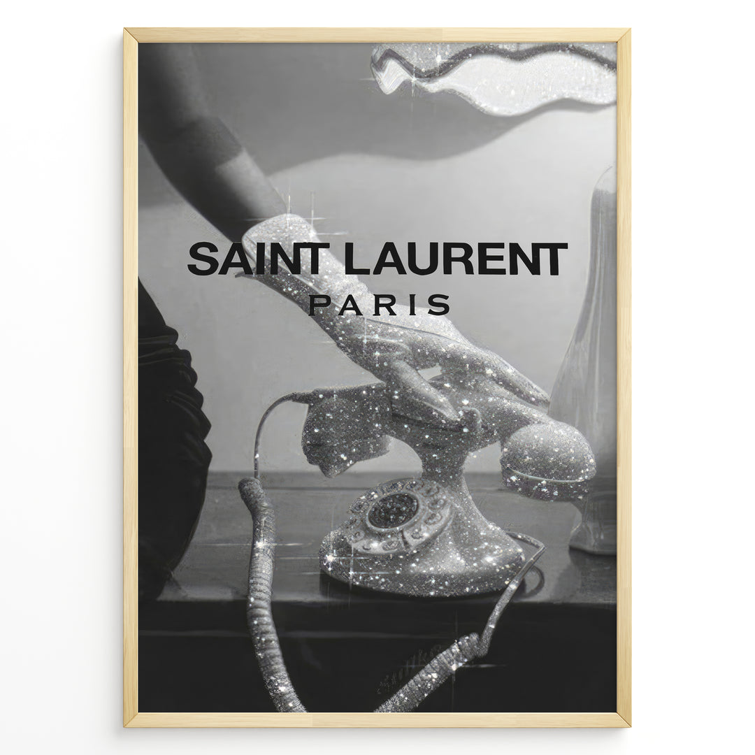Fashion Plakat | Saint Laurent Glamour Art Featuring Glitter Phone and Elegant Hand Plakaty.dk | Black-and-white image of a sparkling vintage rotary phone being held by a glittering, elegant hand, with "SAINT LAURENT PARIS" overlaid in bold text.