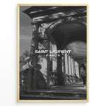 Load image into Gallery viewer, Fashion Plakat | Saint Laurent Paris – Architectural Elegance in Monochrome Plakaty.dk | Black and white photo of classical architecture with arches and columns, overlaid with the Saint Laurent Paris logo, conveying elegance and luxury.
