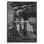 Load image into Gallery viewer, Fashion Plakat | Saint Laurent Paris – Architectural Elegance in Monochrome Plakaty.dk | Black and white photo of classical architecture with arches and columns, overlaid with the Saint Laurent Paris logo, conveying elegance and luxury.
