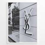 Load image into Gallery viewer, Fashion Plakat | Saint Laurent Paris Storefront – Monochrome Fashion Photography Plakaty.dk | Black and white image of a Saint Laurent Paris storefront featuring the reflective YSL logo on a textured exterior wall with modern architectural details.
