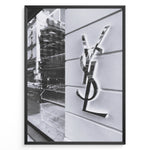Load image into Gallery viewer, Fashion Plakat | Saint Laurent Paris Storefront – Monochrome Fashion Photography Plakaty.dk | Black and white image of a Saint Laurent Paris storefront featuring the reflective YSL logo on a textured exterior wall with modern architectural details.
