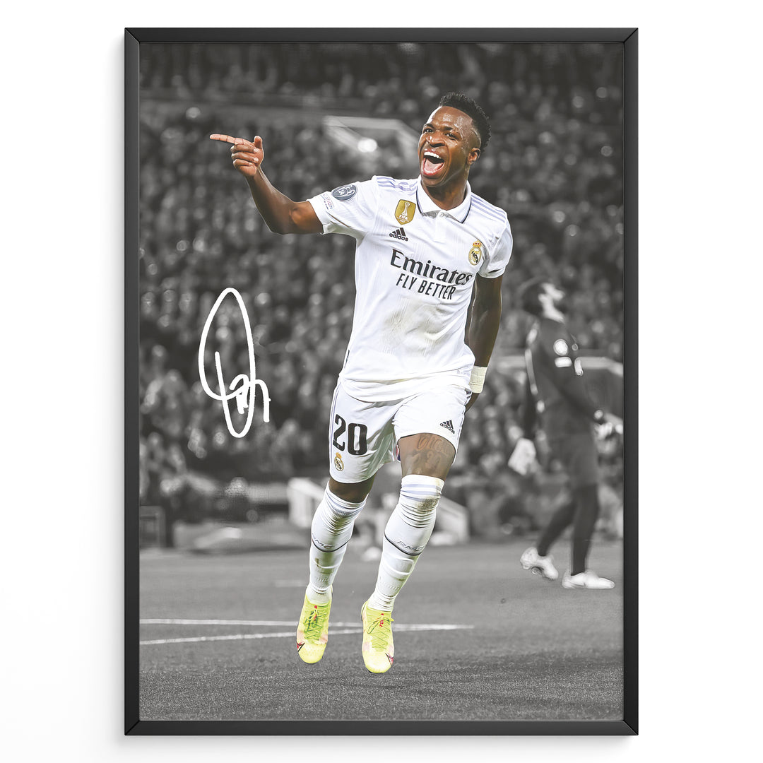 Framed plakat of Vinícius Jr. in a Real Madrid kit celebrating with a pointing gesture, color-highlighted against a black and white background with signature