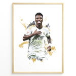 Load image into Gallery viewer, Framed watercolor-style plakat of Vinícius Jr. celebrating in a Real Madrid jersey with a gold artistic background
