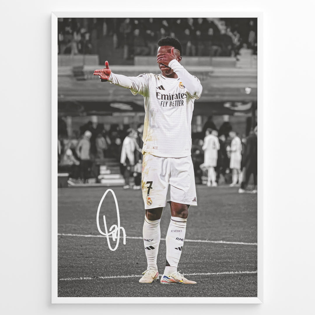 Framed plakat of Vinícius Jr. in a Real Madrid kit doing an eye-cover celebration, with a black and white background and printed signature