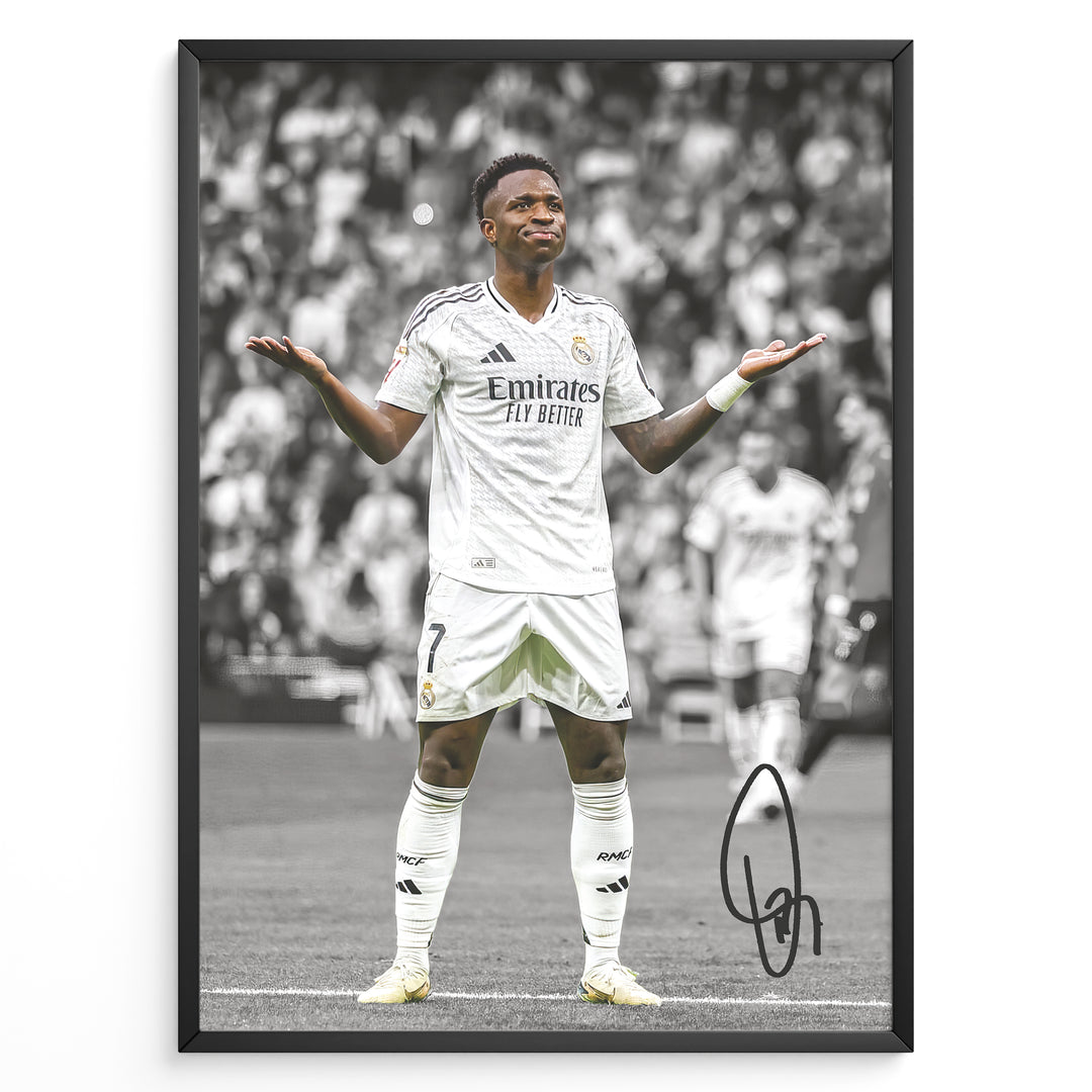 Framed Plakat of Vinícius Jr. in a Real Madrid kit doing a shrug celebration, with a black and white background and visible signature