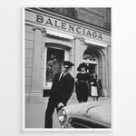Load image into Gallery viewer, Fashion Plakat | Vintage Balenciaga Boutique – Paris Street Fashion Poster Plakaty.dk | Black and white photo of the Balenciaga boutique in Paris with a chauffeur, two stylish women, and a vintage car in the foreground.
