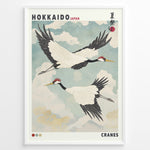 Load image into Gallery viewer, Japanske plakater | Vintage-style Japanese poster featuring two red-crowned cranes flying in a cloudy sky, with the text &quot;Hokkaido Japan&quot; and traditional Japanese characters referencing a summer festival.
