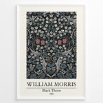 Load image into Gallery viewer, Framed William Morris Black Thorn 1892 art print plakat with detailed white and red flowers and blue-green leaves on a black background.
