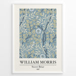 Load image into Gallery viewer, William Morris Sweet Briar 1887 botanical floral pattern art print with blue and beige leaves and flowers in black frame plakat.
