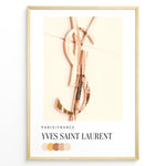 Load image into Gallery viewer, Fashion Plakat | Yves Saint Laurent Paris – Rose Gold Emblem Poster Plakaty.dk | Rose gold Yves Saint Laurent logo on a soft beige background with a neutral color palette and Paris/France label beneath.
