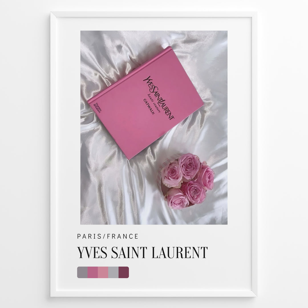 Fashion Plakat | Yves Saint Laurent Pink Book on Silk – Paris Fashion Decor Plakaty.dk | Yves Saint Laurent pink Catwalk book placed on white silk fabric with pink roses beside it, representing Parisian luxury and soft elegance.