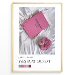 Load image into Gallery viewer, Fashion Plakat | Yves Saint Laurent Pink Book on Silk – Paris Fashion Decor Plakaty.dk | Yves Saint Laurent pink Catwalk book placed on white silk fabric with pink roses beside it, representing Parisian luxury and soft elegance.
